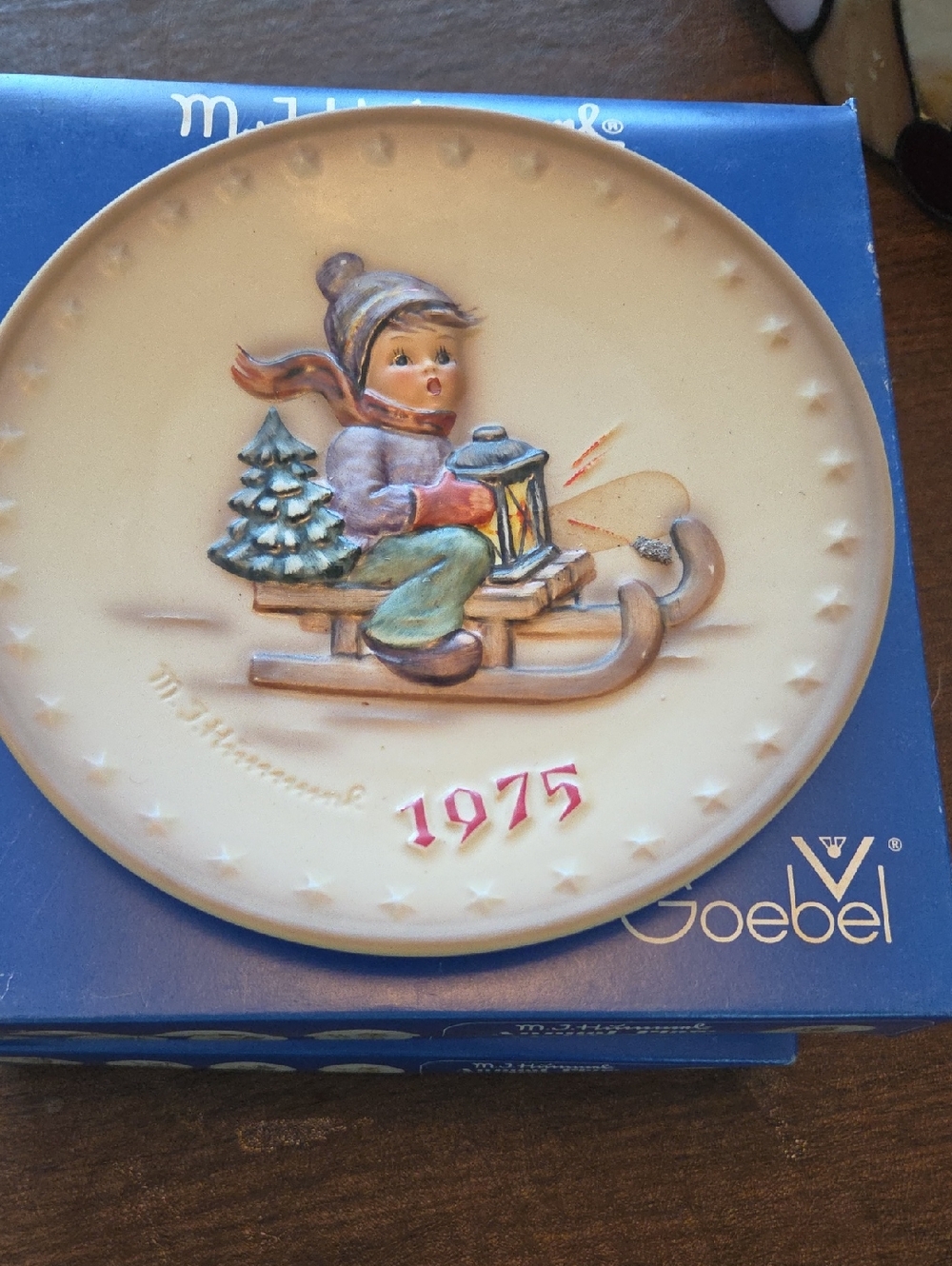 1975 Goebel Beige and Pastel Hummel Plate with Sledding Child
